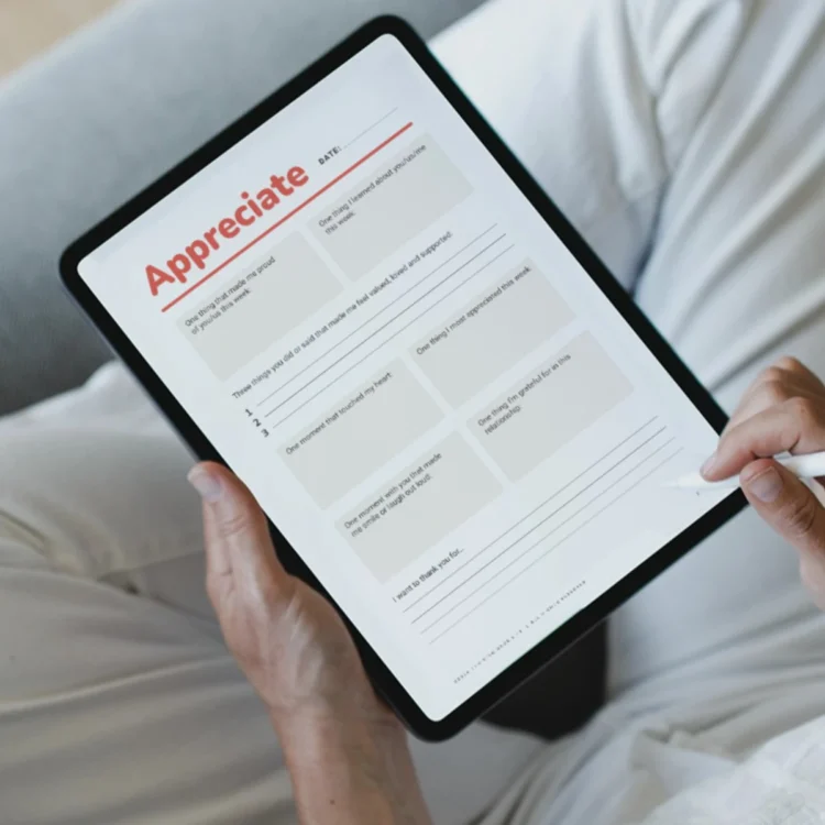 Person using relationship check-in journal on tablet with stylus.