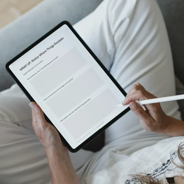Person using Fight Clean Not Dirty digital conflict workbook on tablet.