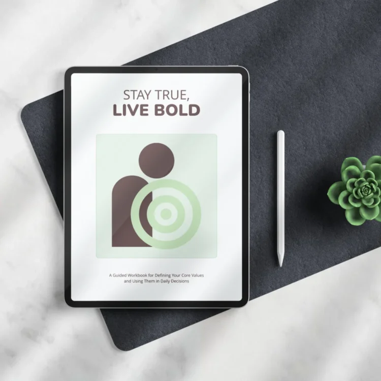 Digital core values workbook placed on a desk next to a stylus and a small plant.