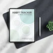 Digital habit tracker workbook displayed on a tablet on a desk next to a stylus and plant.
