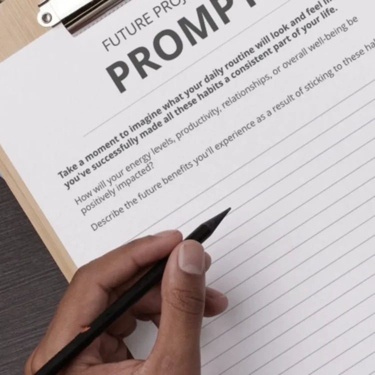 Printable habit tracker prompt page being written on by hand.