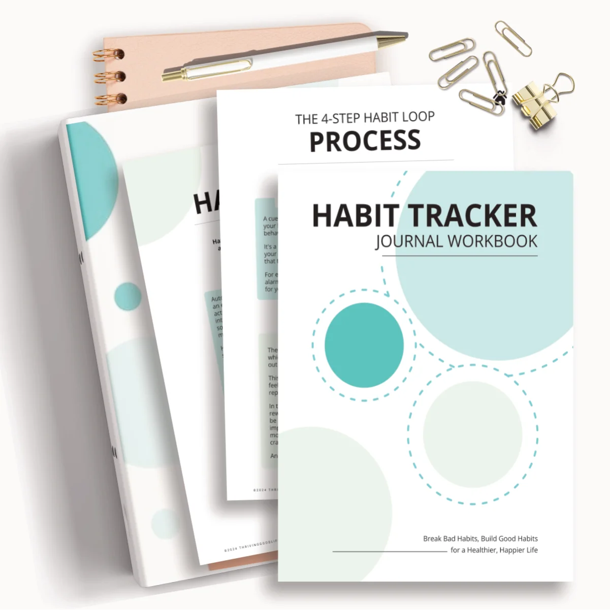 flatlay printable habit tracker journal workbook PDF pages on top of ring binder and notebook