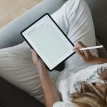 woman sitting with ipad featuring journal page from the right fit relationship needs workbook.