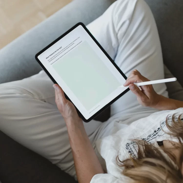 woman sitting with ipad featuring journal page from the right fit relationship needs workbook.