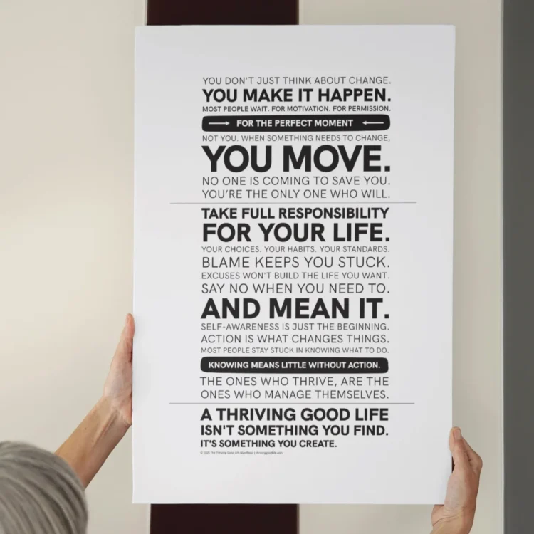 Hands holding the Thriving Good Life Manifesto Poster up against a wall — minimalist wall art encouraging personal accountability and action.