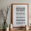 Thriving Good Life Manifesto Poster in wooden frame above awooden desk beside vases — motivational decor reminder to take responsibility and act.